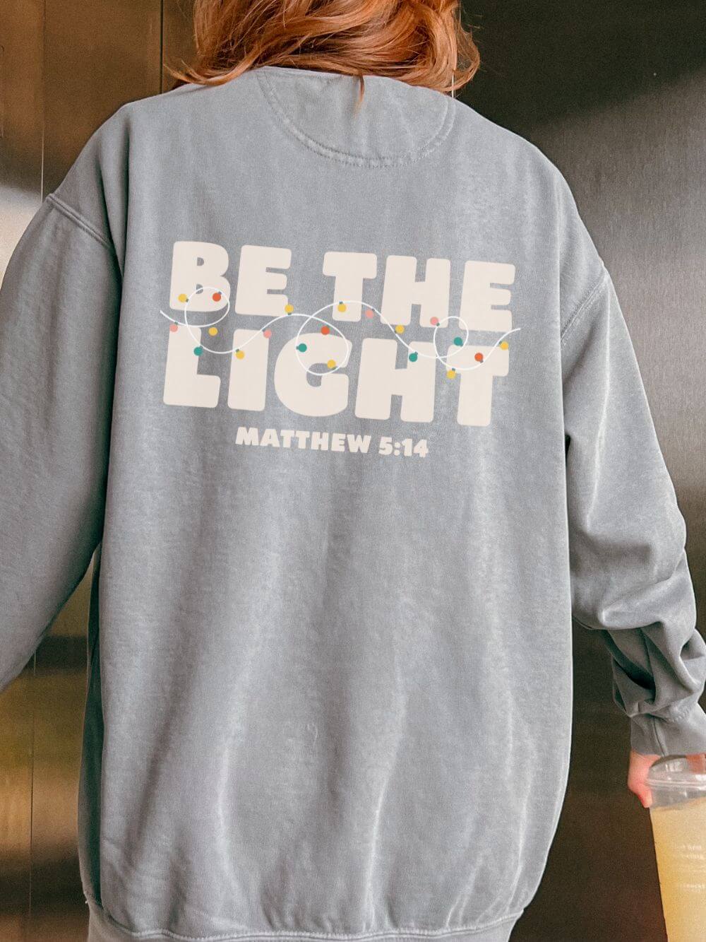 Be The Light Matthew 5:14 Christian Faith Comfort Colors Christmas Crewneck Sweatshirt - Sydney So Sweet