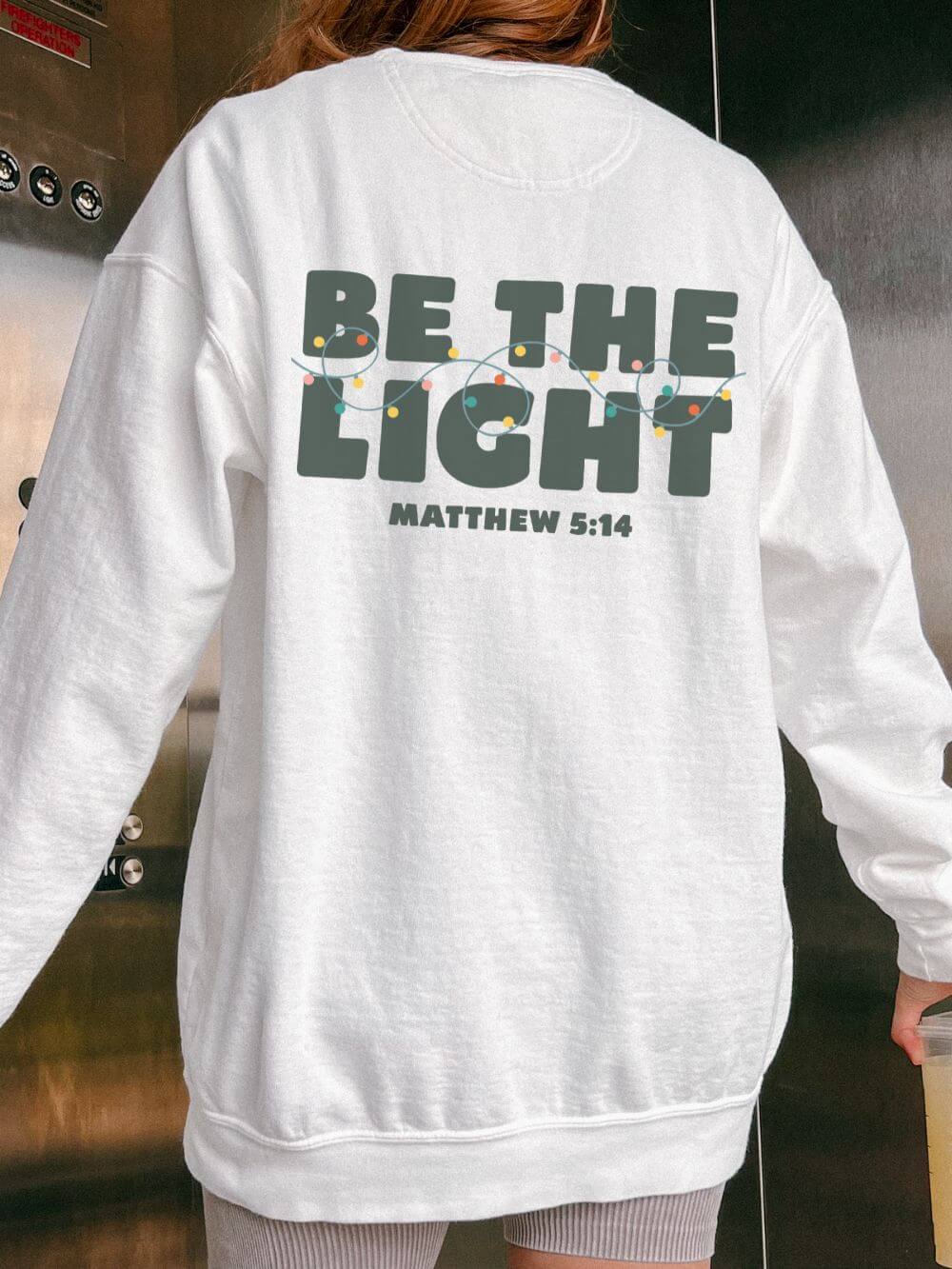 Be The Light Matthew 5:14 Christian Faith Comfort Colors Christmas Crewneck Sweatshirt - Sydney So Sweet