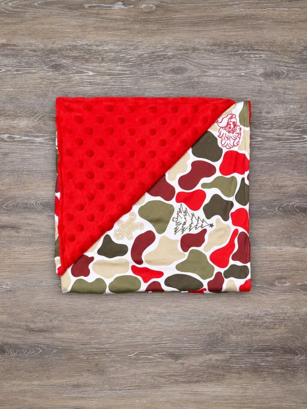 Christmas camouflage baby blanket with red minky dot backing folded to show the patterned front and reverse