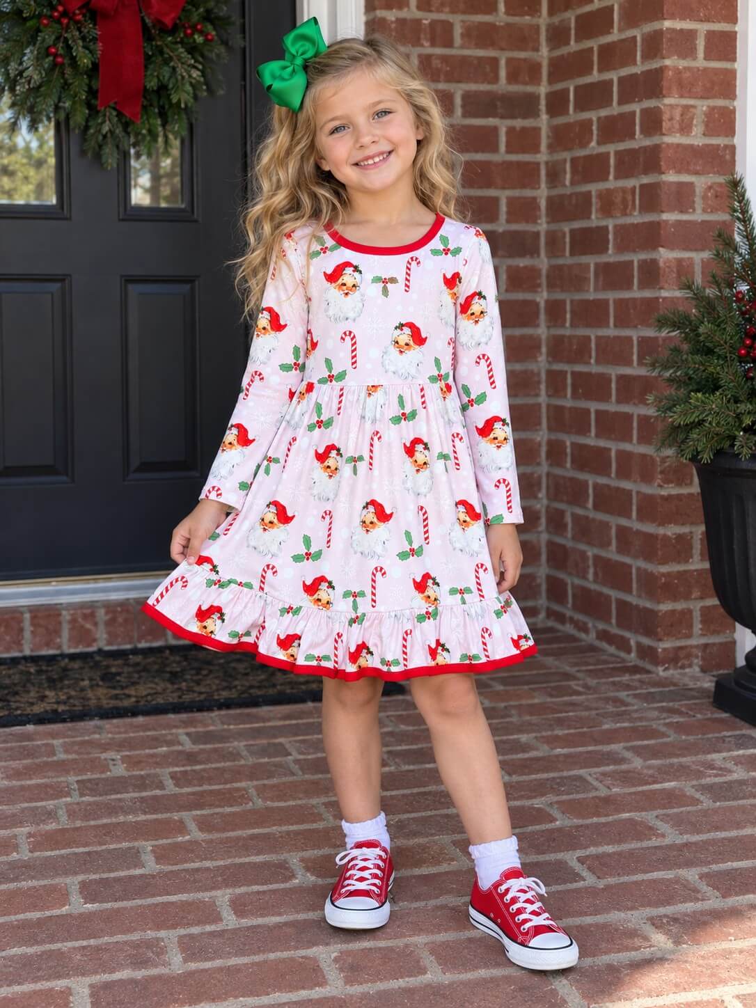 Girls vintage Santa and candy cane Christmas dress with red trim worn by a child