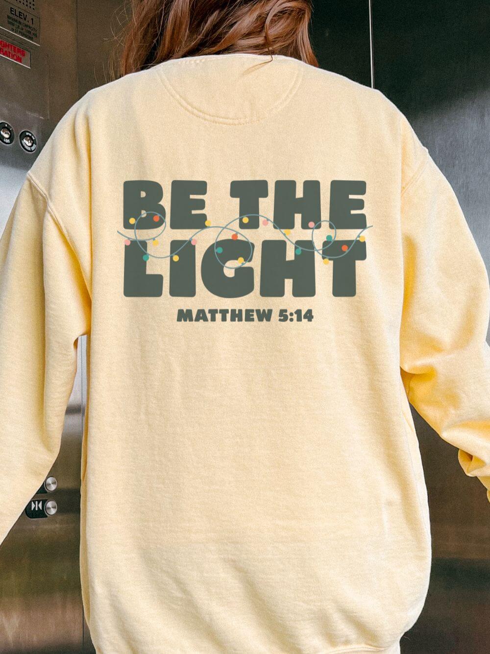 Be The Light Matthew 5:14 Christian Faith Comfort Colors Christmas Crewneck Sweatshirt - Sydney So Sweet
