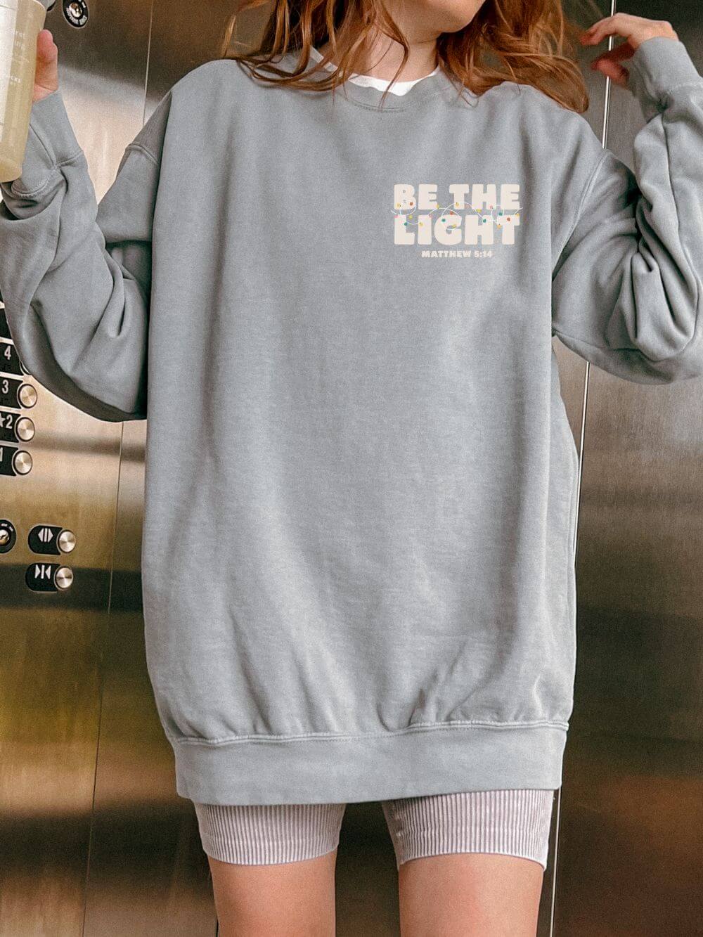 Be The Light Matthew 5:14 Christian Faith Comfort Colors Christmas Crewneck Sweatshirt - Sydney So Sweet