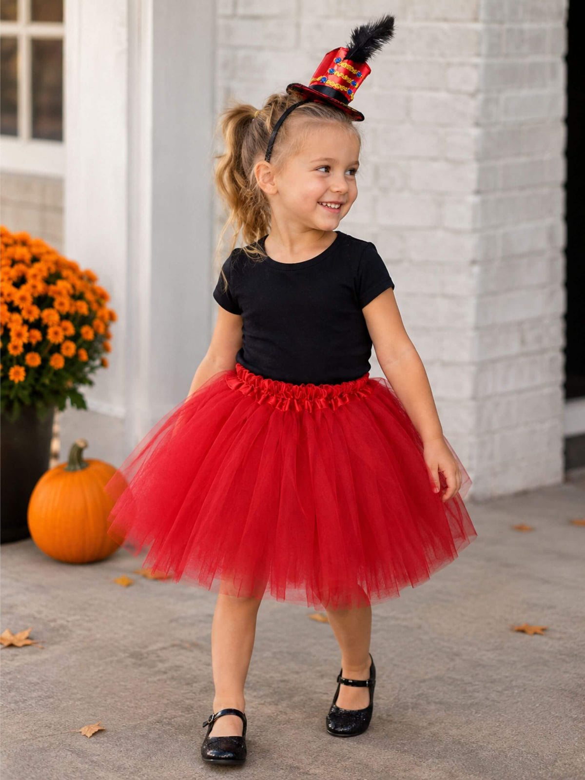 Girl wearing red ringmaster costume with tutu and mini hat headband